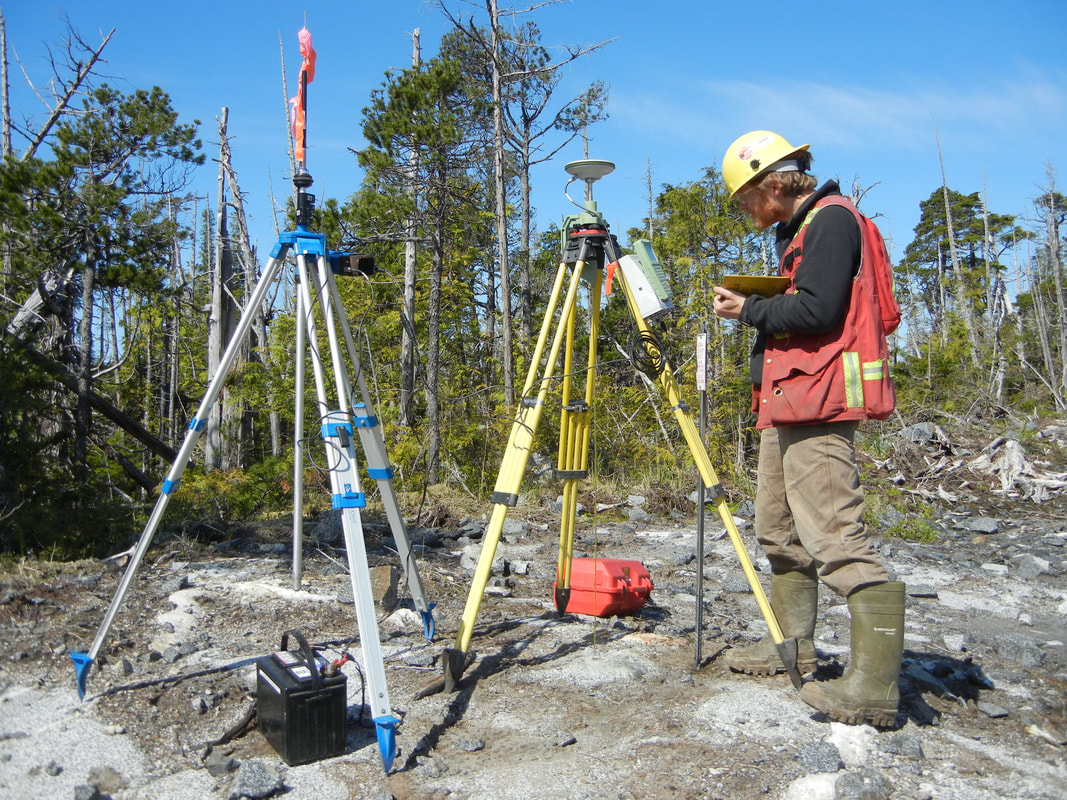 Employee setting up a base station for a GPS survey